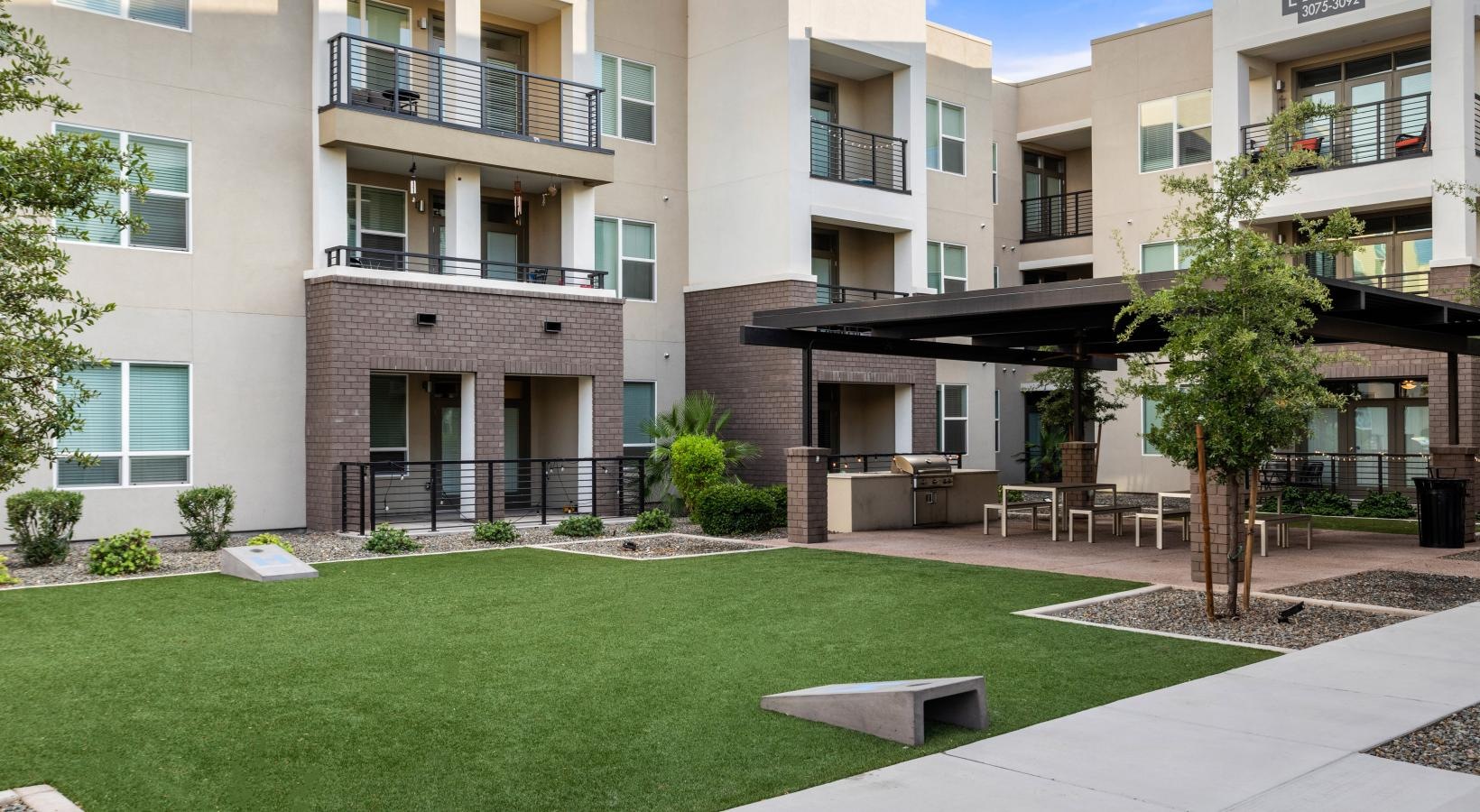 The essence of exceptional living a building with a lawn and trees