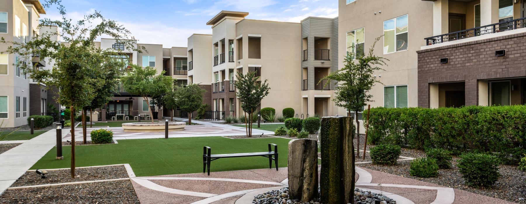 a courtyard with trees and buildings