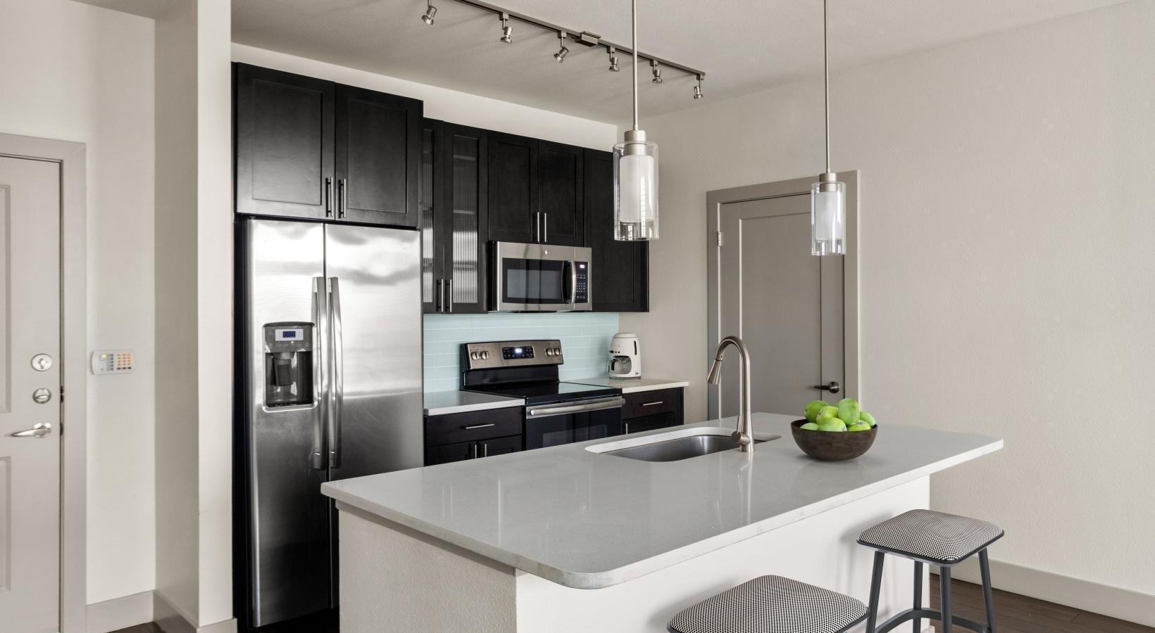 Spacious kitchens with thoughtful details a kitchen with black cabinets