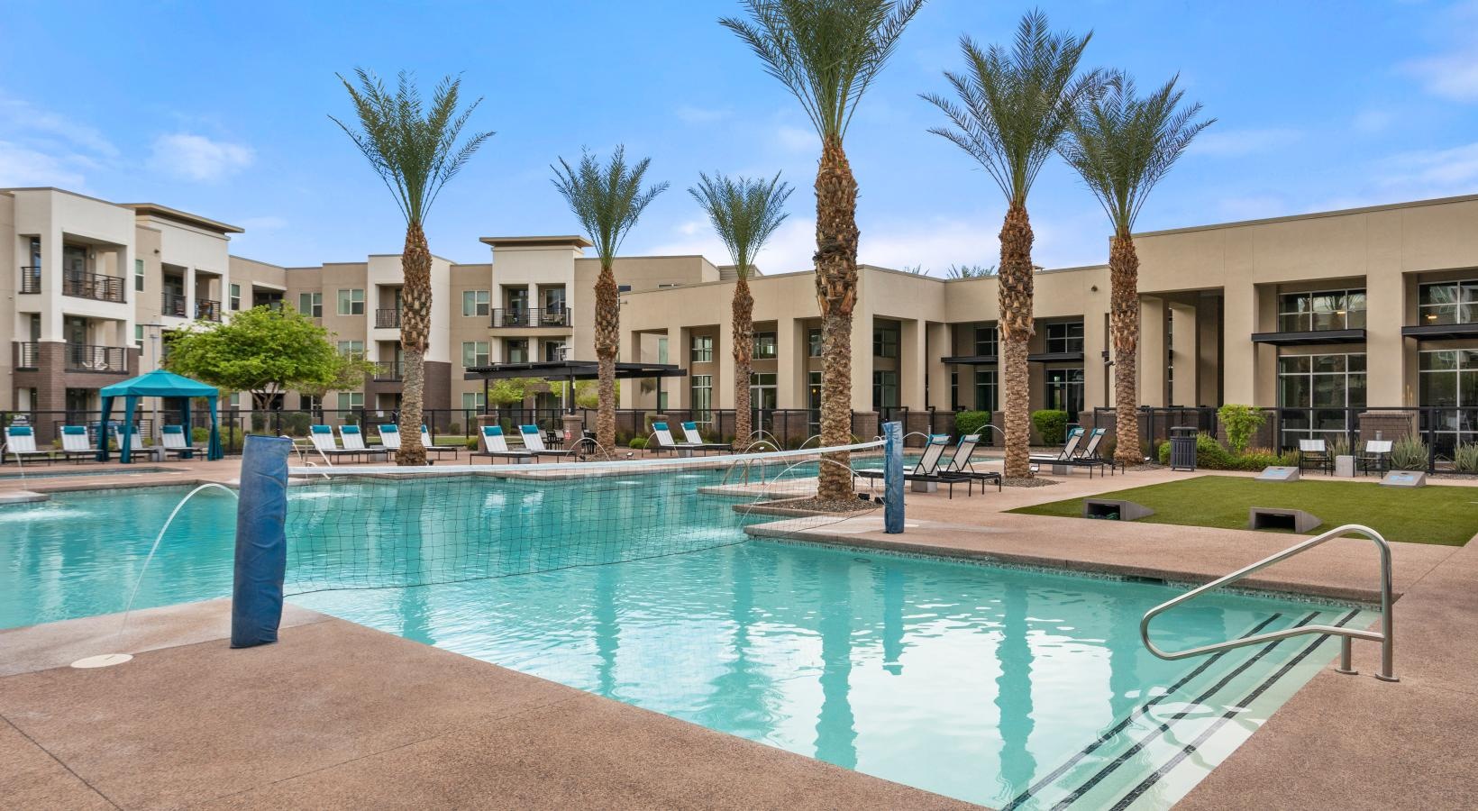 Resort-style swimming pool a swimming pool in front of a building