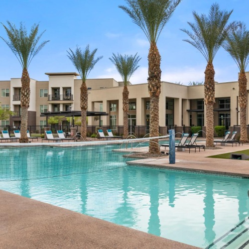 Resort-style swimming pool a swimming pool in front of a building