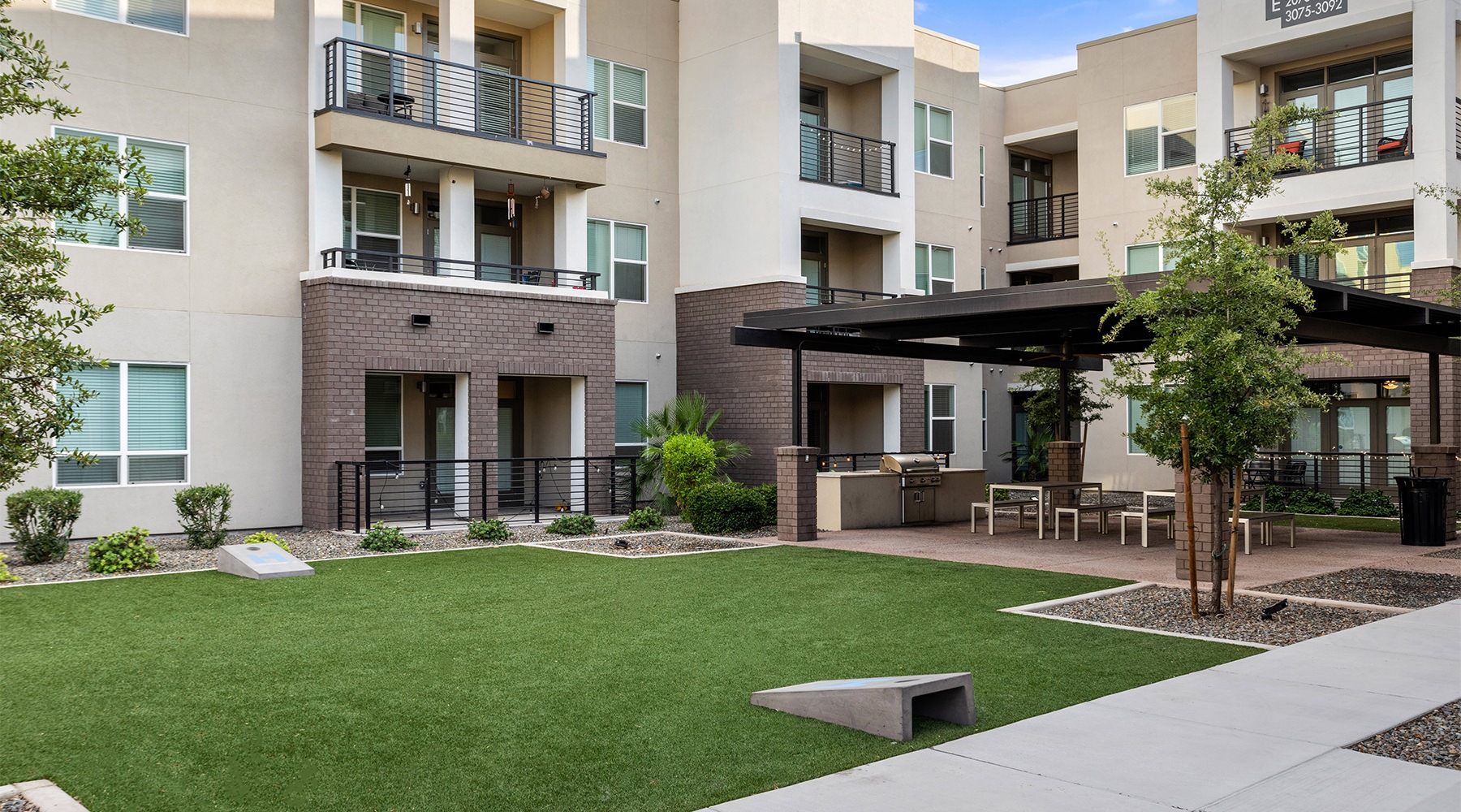 a building with a lawn and trees