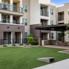 a building with a lawn and trees